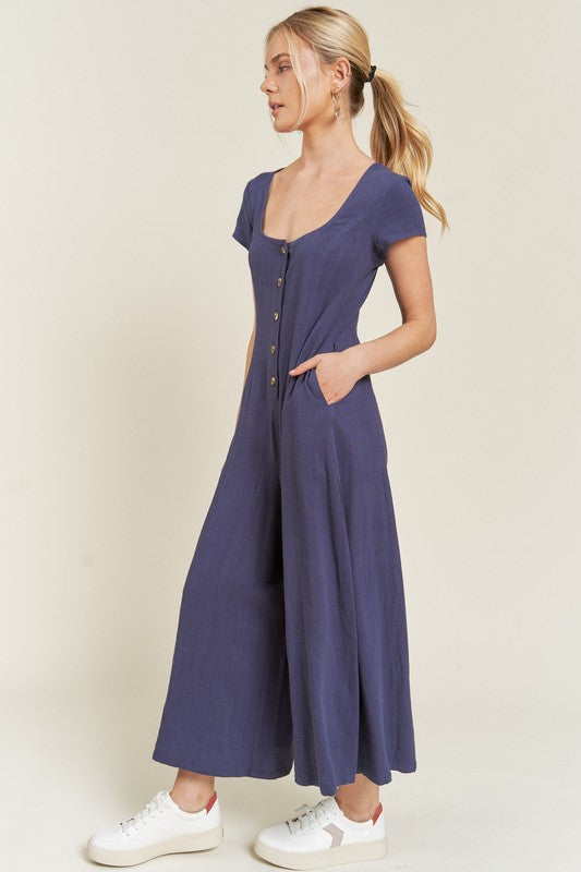 Navy Seona Linen Plus Size Jumpsuit side view showcasing side pockets and lightweight fabric.