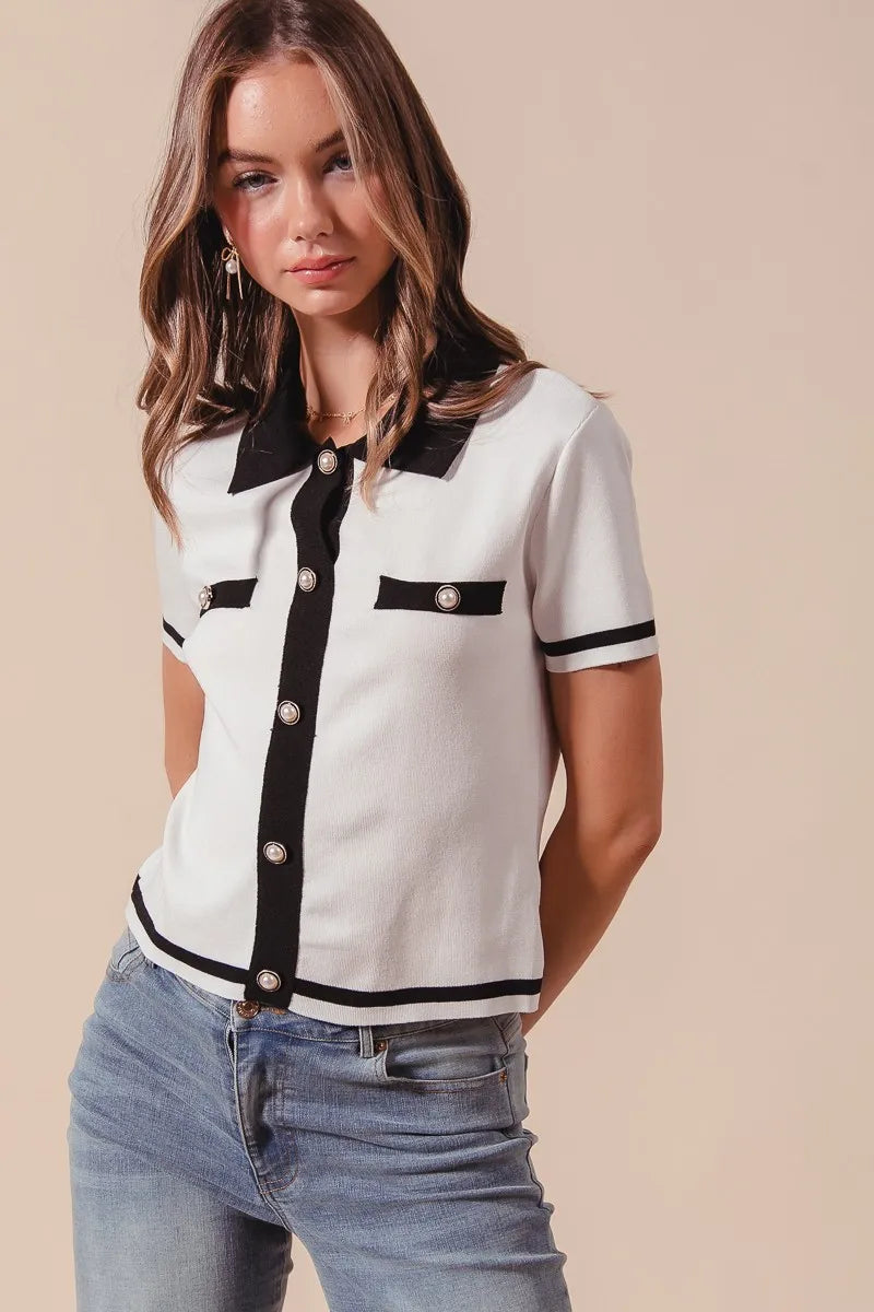 Front view of Novah ivory knit sweater shirt top with jeans, featuring button-down front and black contrast trim