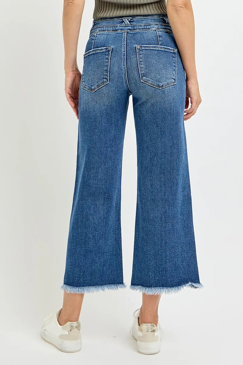 High rise wide leg crop jeans with back patch pockets and raw hem finish.