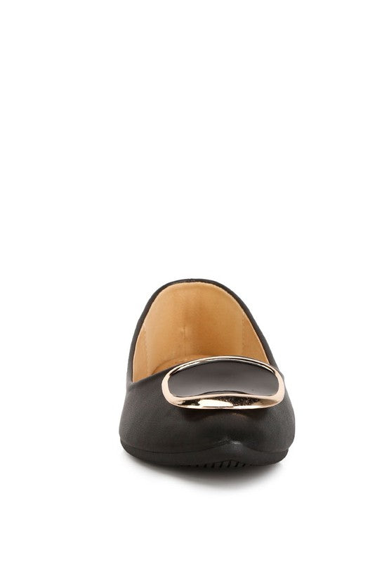 Front view of black ballet flats showing metallic brooch detail