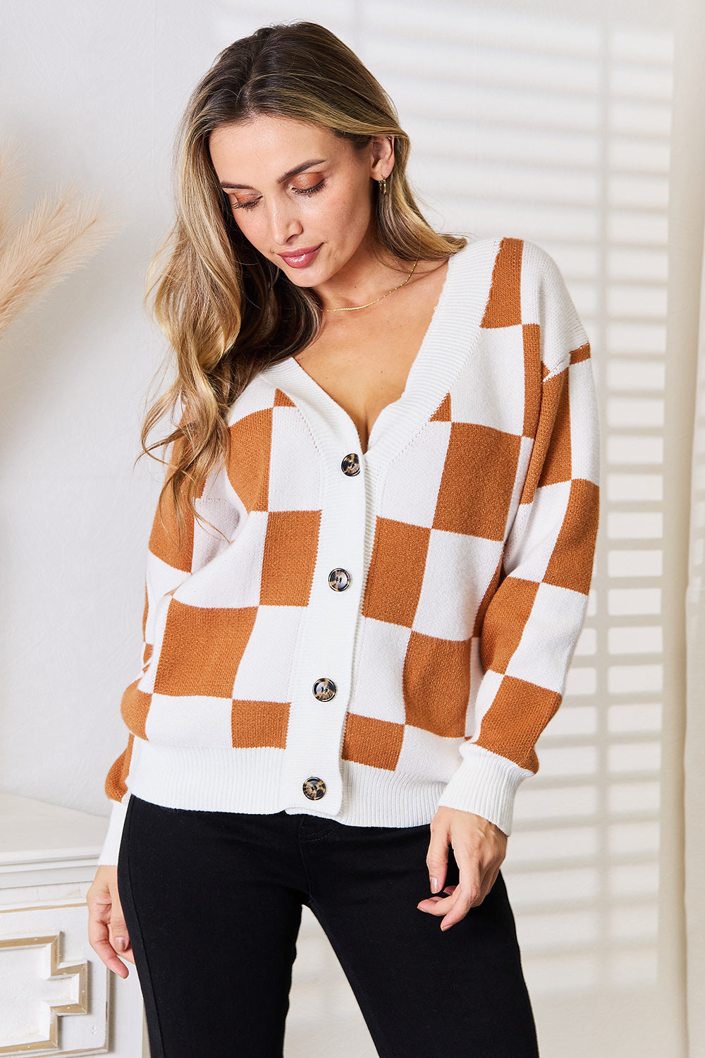 Model wearing Tauni Checkered Button-Up Cardigan, front view with V-neckline and button closure