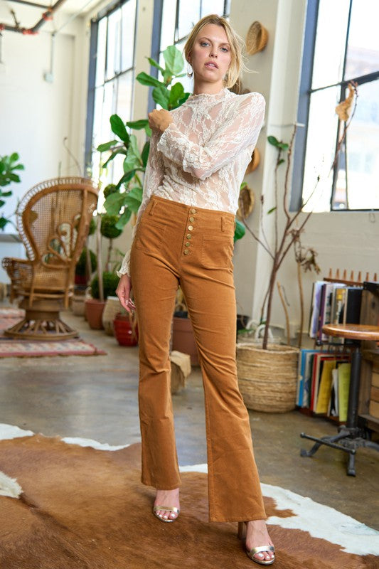 Full body view of Taran Plus Size Corduroy Flare Pants in camel styled with neutral top