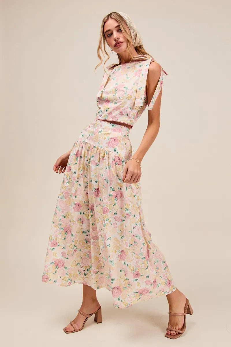 Side view of Soraya Floral Two-Piece Set with bow-tied straps and flowing pink floral tiered maxi skirt.