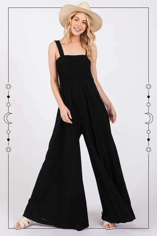 Effortless elegance in a sleeveless wide leg jumpsuit with a square neck and side pockets for functionality and style.