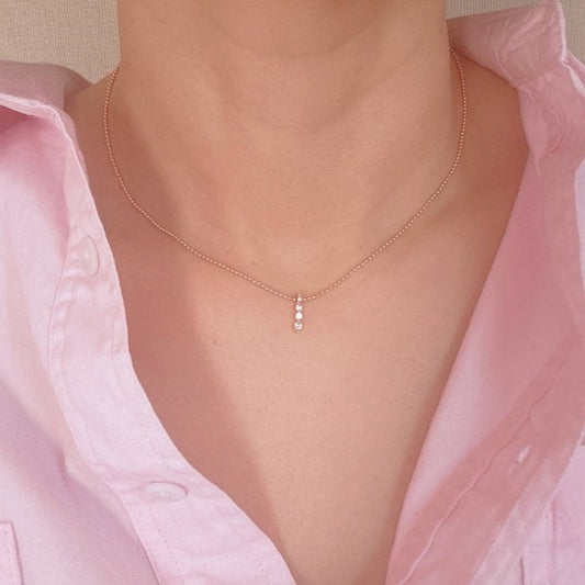 Woman wearing Three Sparkles Necklace with dainty three-drop crystal pendant