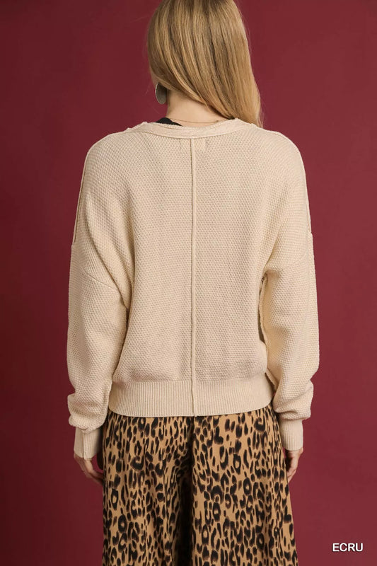 Uma Chunky Cable Knit Cardigan – back view in soft ecru, cropped length and classic fit.