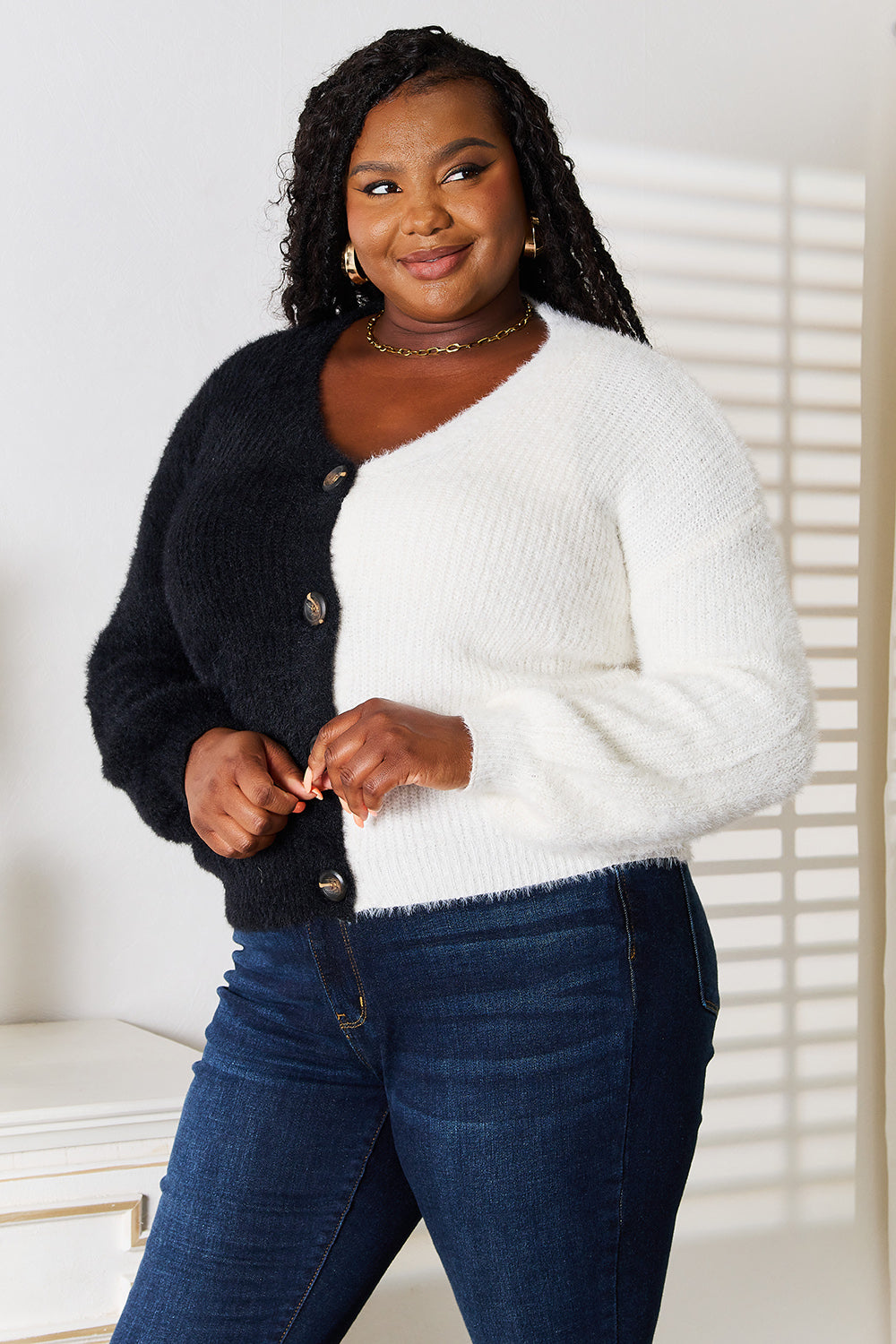 Plus size front view of Nevis Contrast Cardigan buttoned, showing V-neckline and sleek black trim.