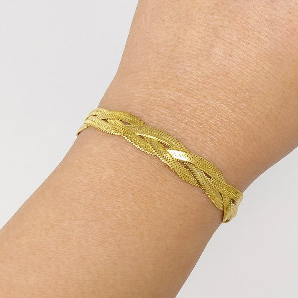 Braided Herringbone Chain Bracelet in gold on model's wrist.
