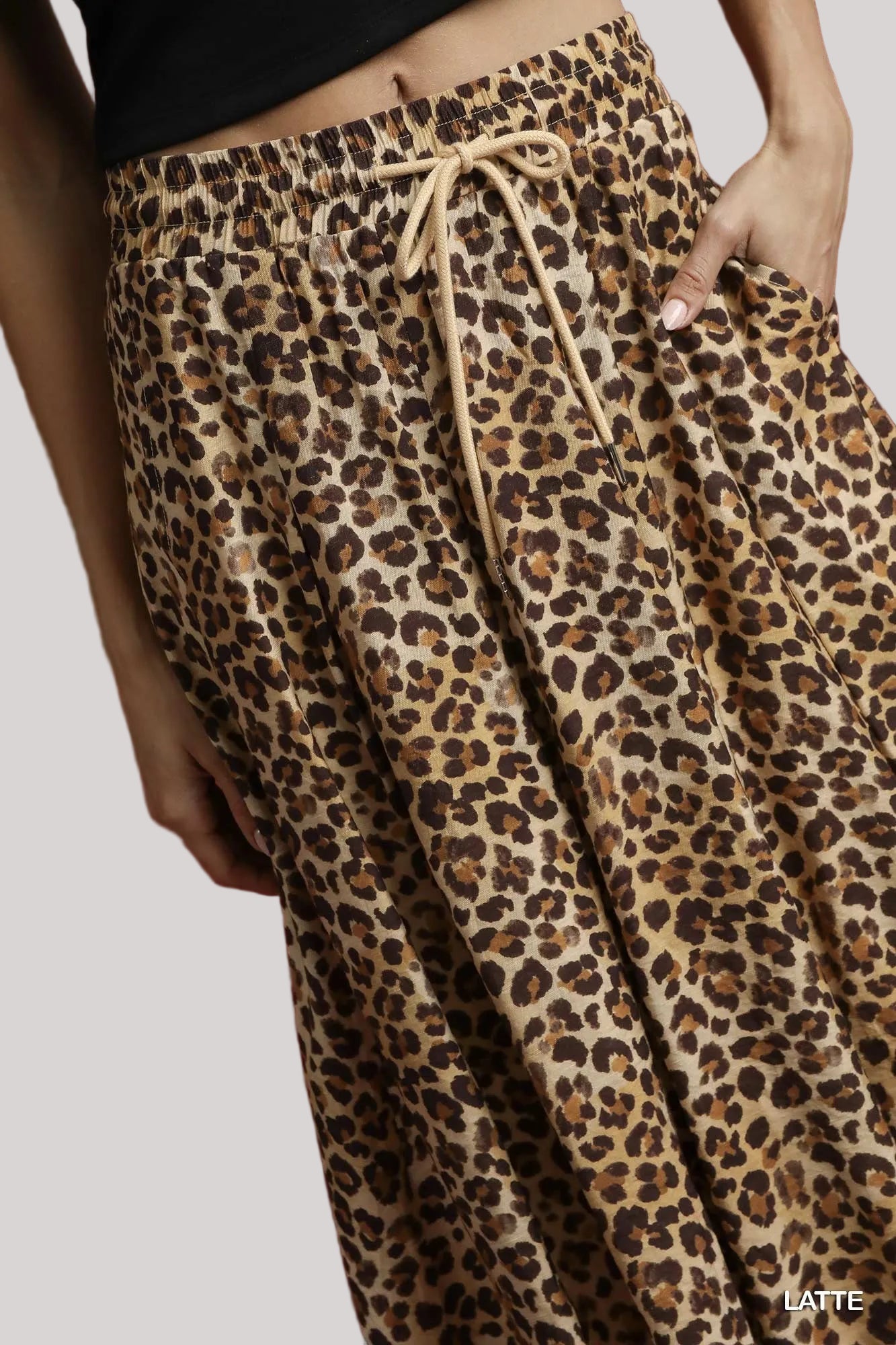 Close up of leopard print fabric and drawstring waist detail.