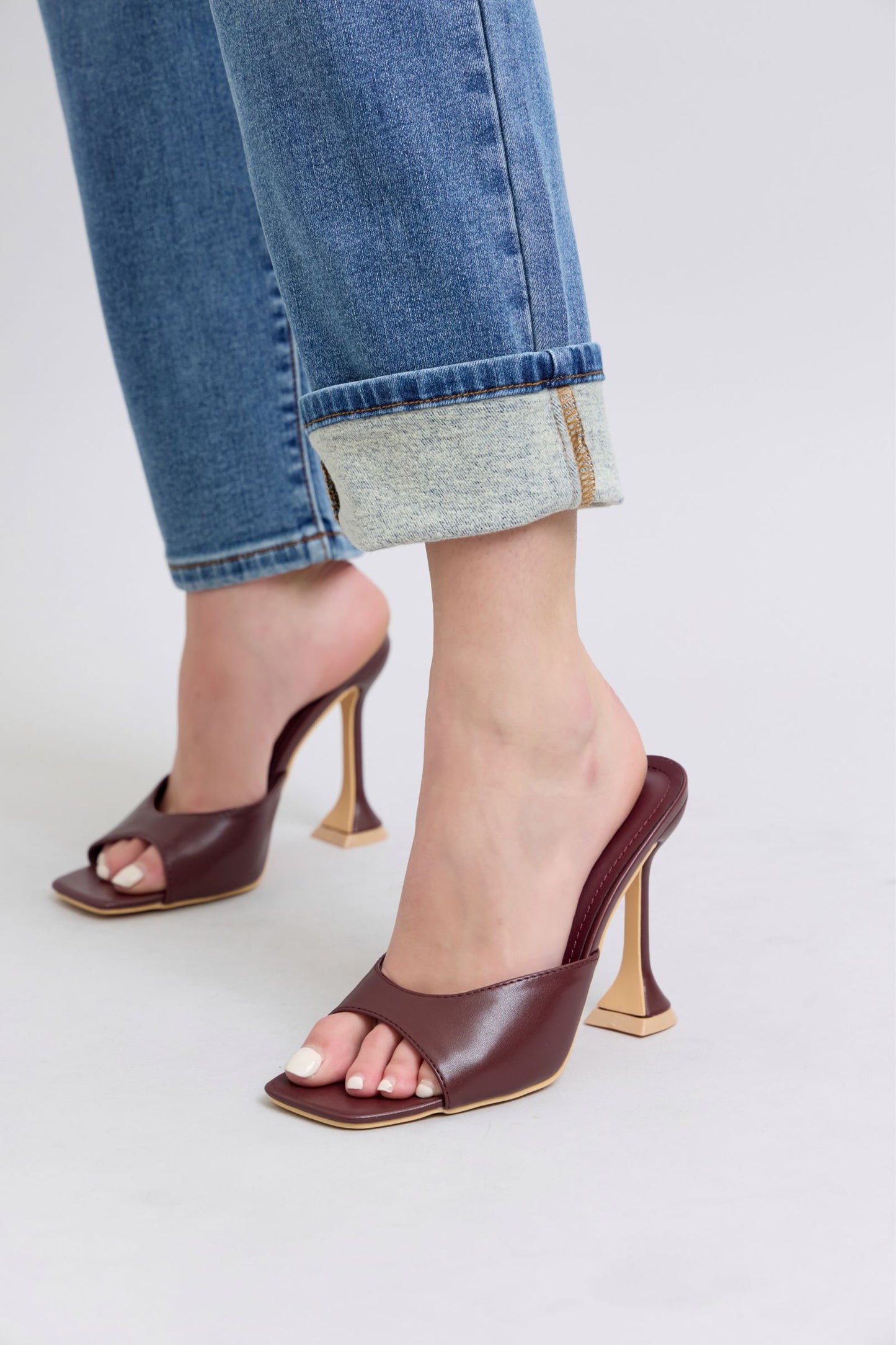 Close up of cuffed ankle detail on Judy Blue straight-leg jeans, medium wash with thermal finish.