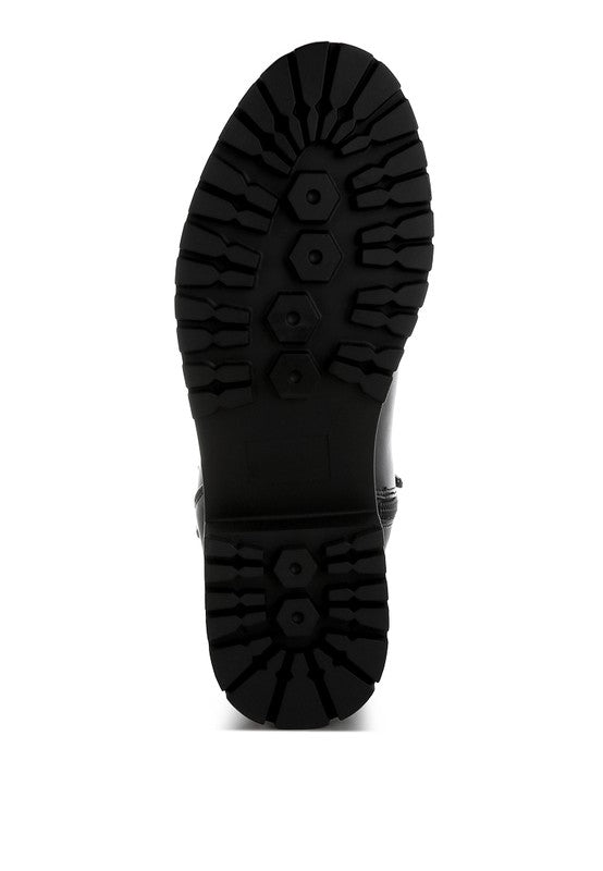 Bottom view of black Antorin chunky buckle ankle boots with anti-skid lug sole.