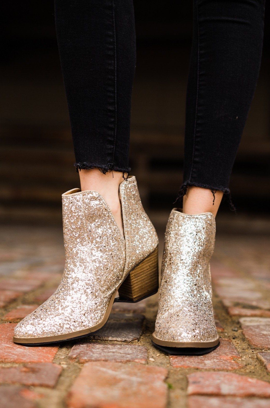 Gold glitter booties with a 3-inch heel, rubber soles, and a sparkling finish for a glamorous party look.