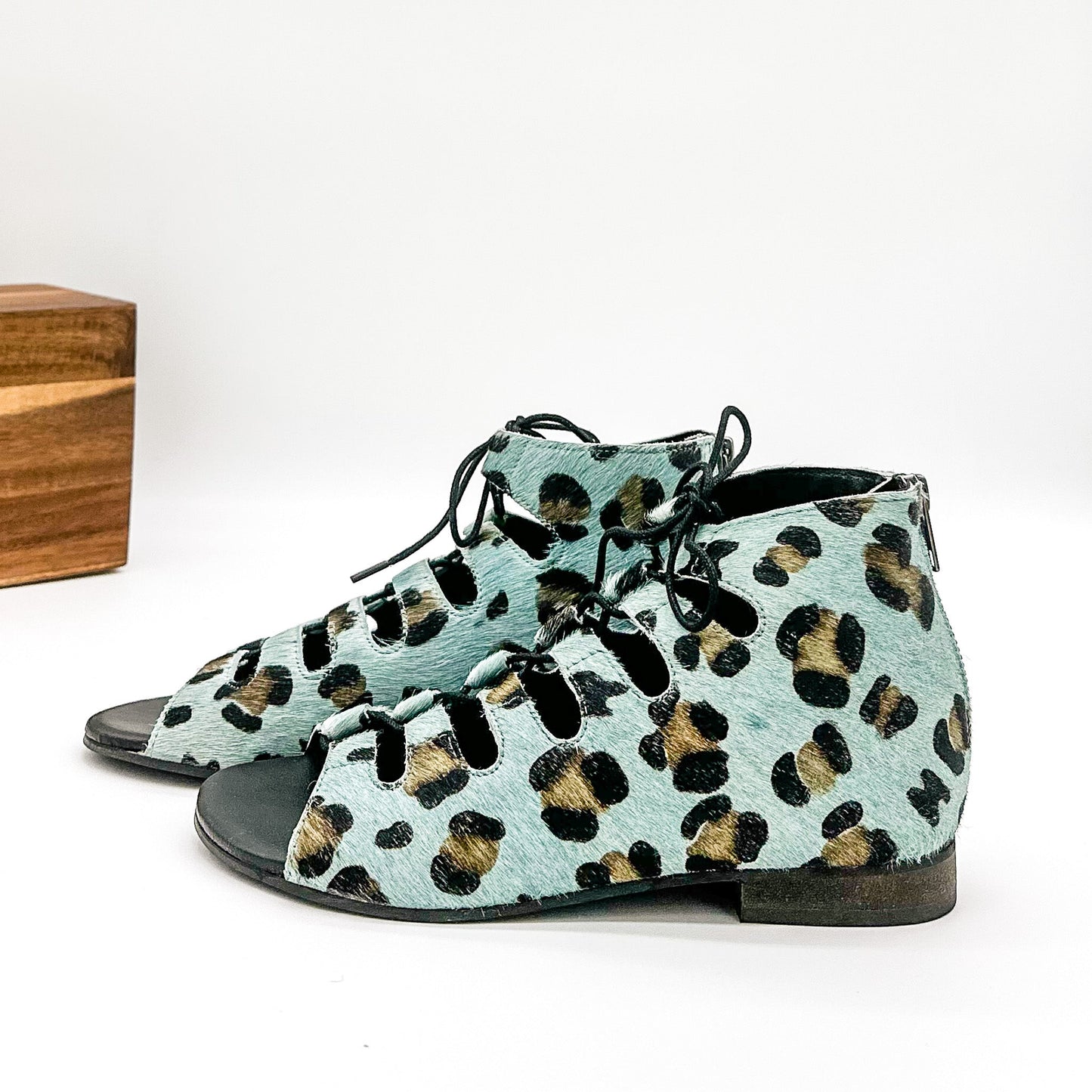 Side view of Nola Teal Leopard Sandals highlighting genuine hide upper and .5-inch heel