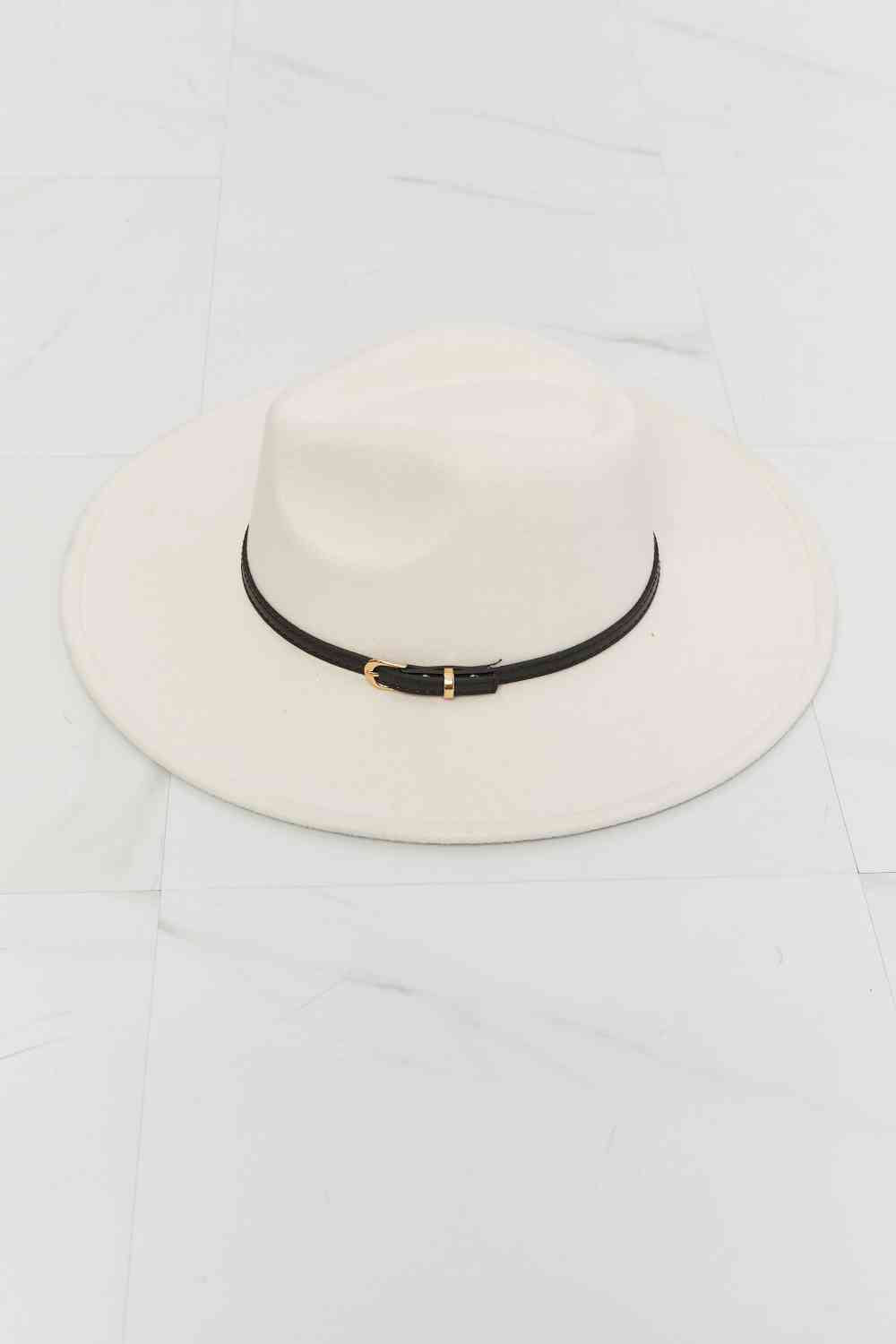 Beige fedora hat with a wide brim, a thin black belt detail with gold hardware, and adjustable straps for a customizable fit.
