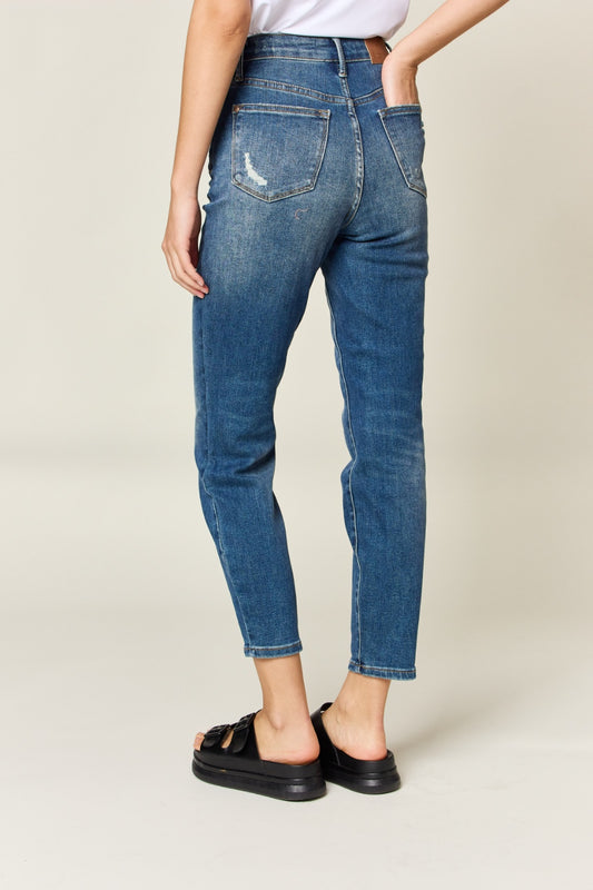 Judy Blue High Waist Slim Jeans in dark denim, featuring tummy control, a zip fly, and a flattering, highly stretchy fit. It has a slim, long leg and high waist.