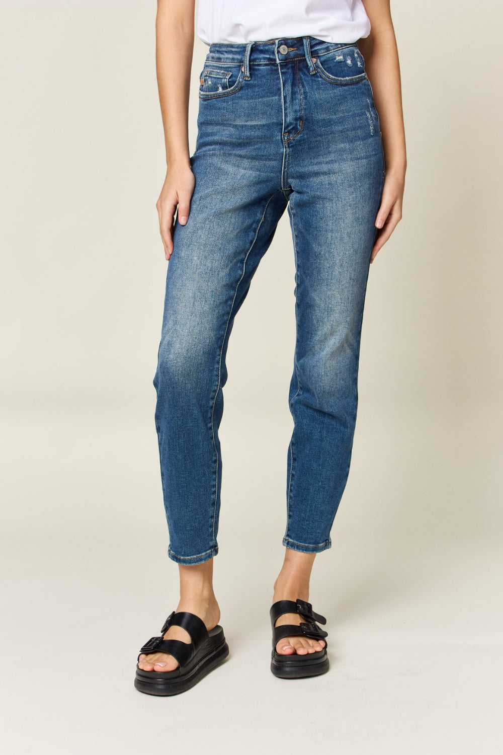 Judy Blue High Waist Slim Jeans in dark denim, featuring tummy control, a zip fly, and a flattering, highly stretchy fit. It has a slim, long leg and high waist.