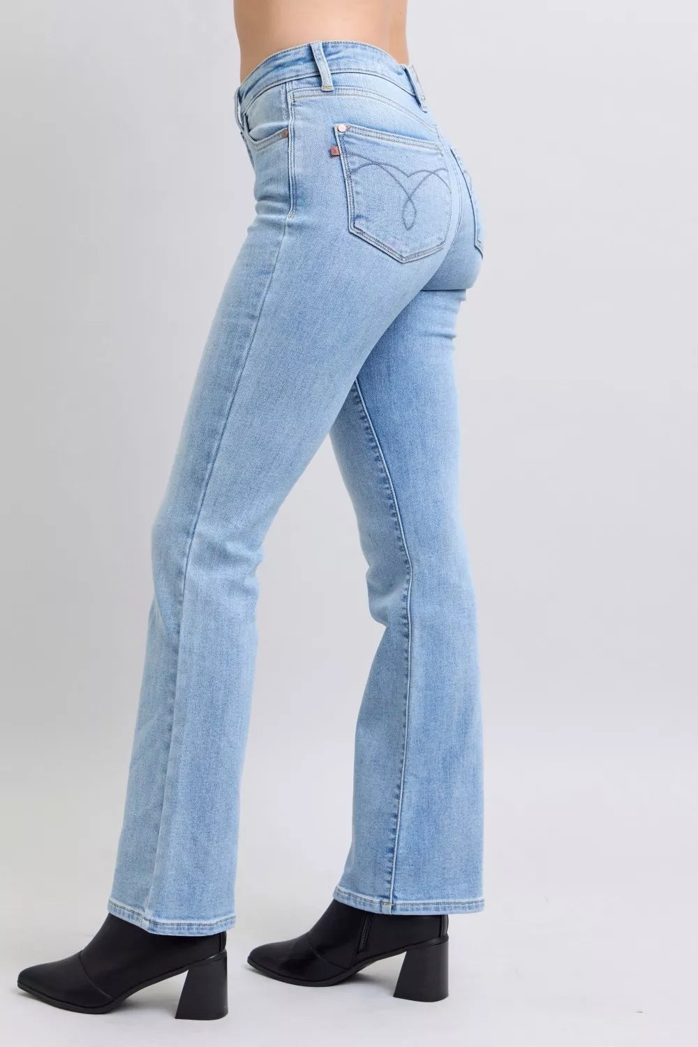 Side angle of Misha Mid Rise Thermal Bootcut Jeans highlighting thermal denim fabric.