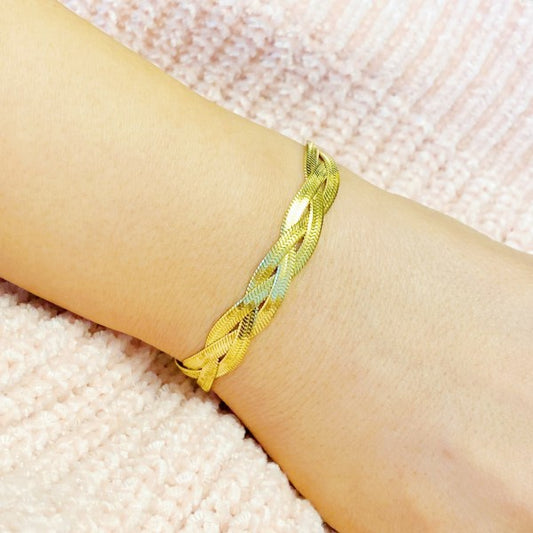 Braided Herringbone Chain Bracelet in gold, three-strand weave, adjustable fit shown on wrist.