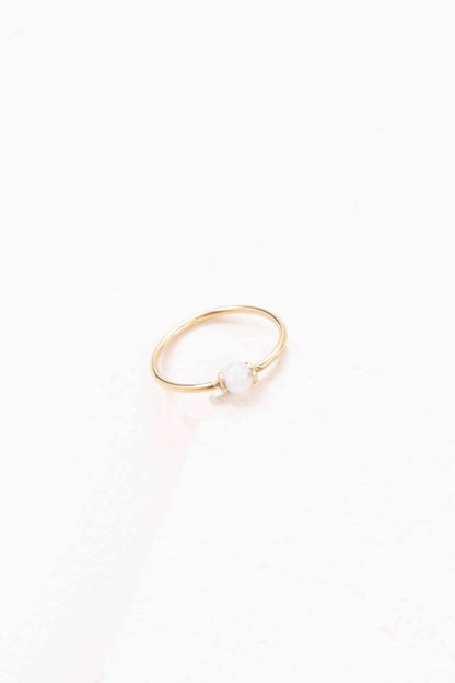 Becca White Stone Ring with slim gold band and circular white stone accent, front view