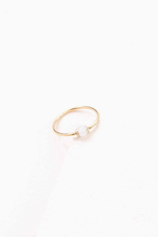Becca White Stone Ring with slim gold band and circular white stone accent, front view