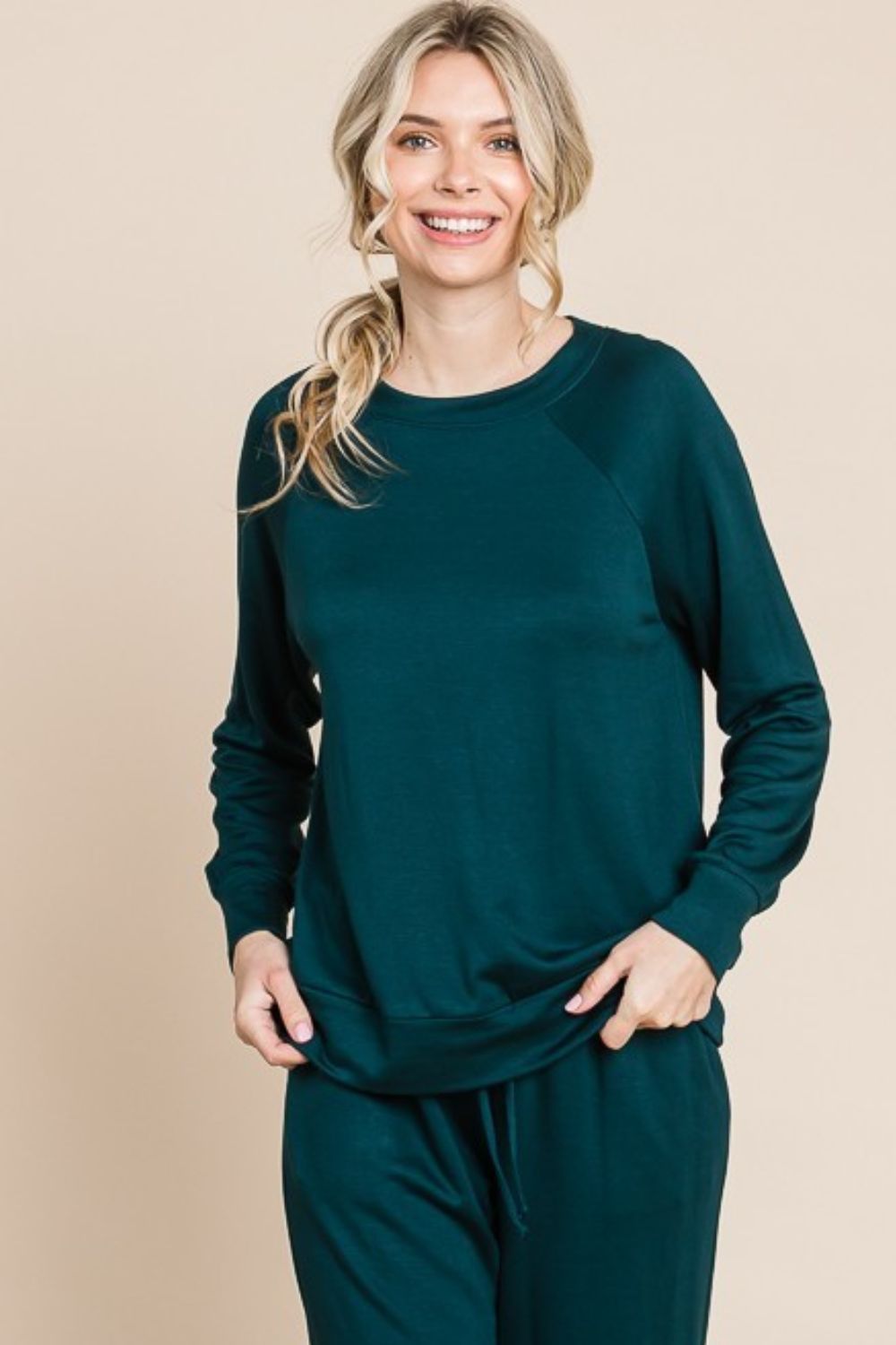 Hunter green lounge set with a round-neck top, raglan sleeves, and drawstring pants.