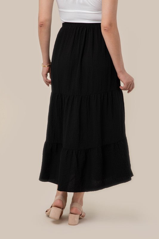 Tiered maxi skirt with elastic waistband in black. Flowy silhouett, lined for full coverage.