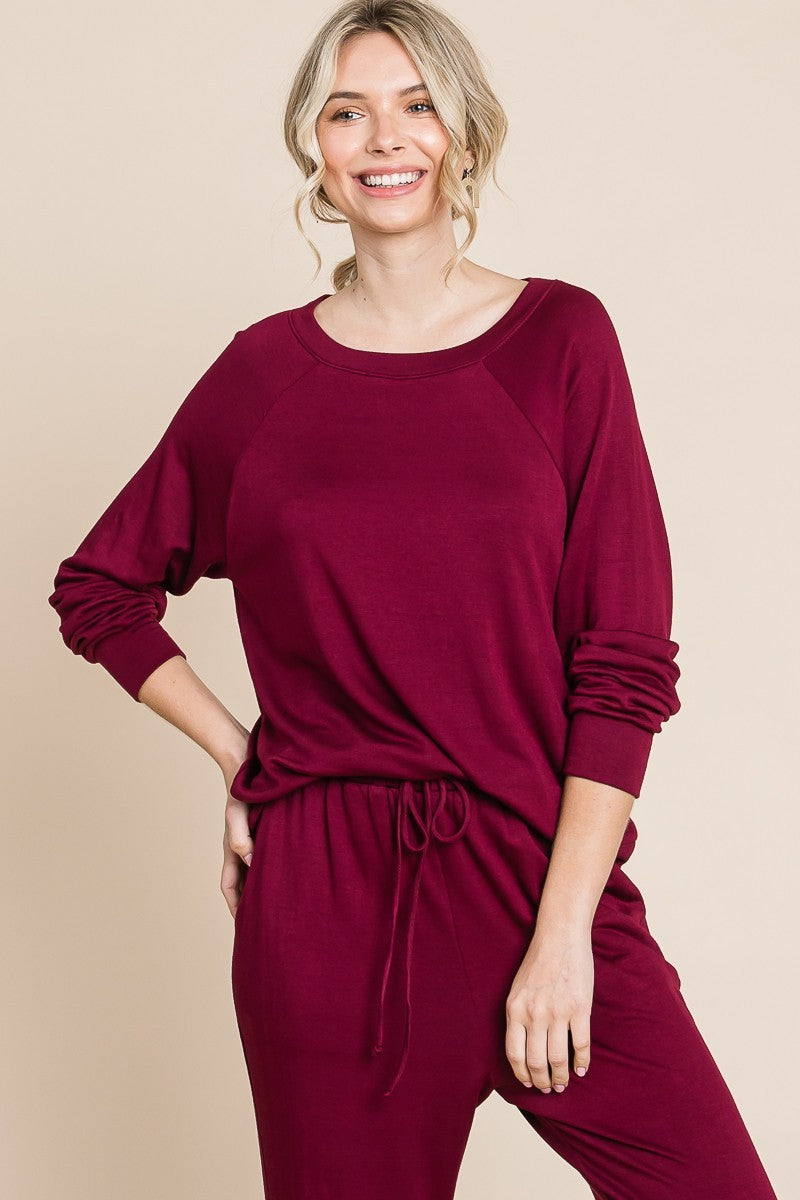 Burgandy lounge set with a round-neck top, raglan sleeves, and drawstring pants.