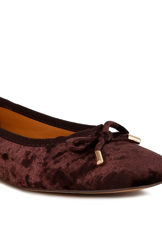 Brown velvet ballerina flats with a closed square toe, bow detail on the vamp, and cushioned insoles for comfort.