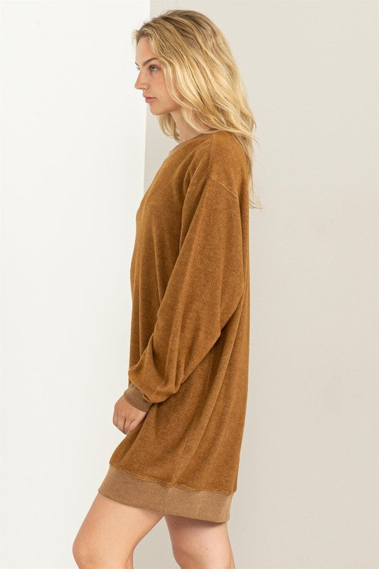 Pale brown girlfriend sweatshirt mini dress with a crew neckline and cuffed hem, drop shoulders, long sleeves, and a relaxed fit. 