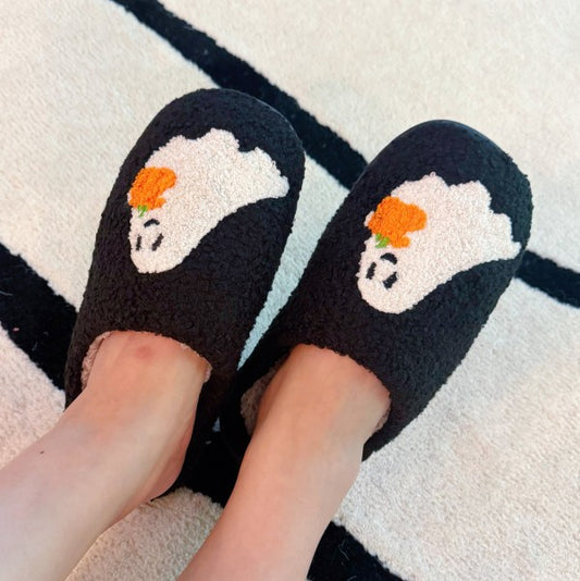Woman wearing Spooky Ghost Cozy Slippers at home, styled for cozy Halloween lounging.