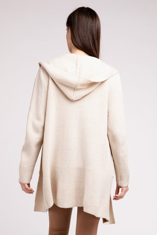 Sand Beige sweater cardigan with long sleeves, front pockets, and a hooded neckline. 