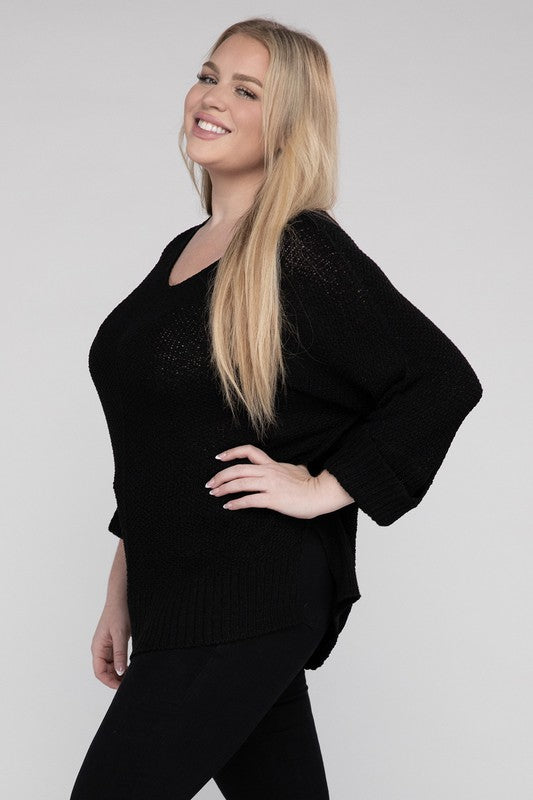 Black plus size crew neck sweater with a loose fit, side slits, long sleeves, and a cozy knit fabric for warmth.