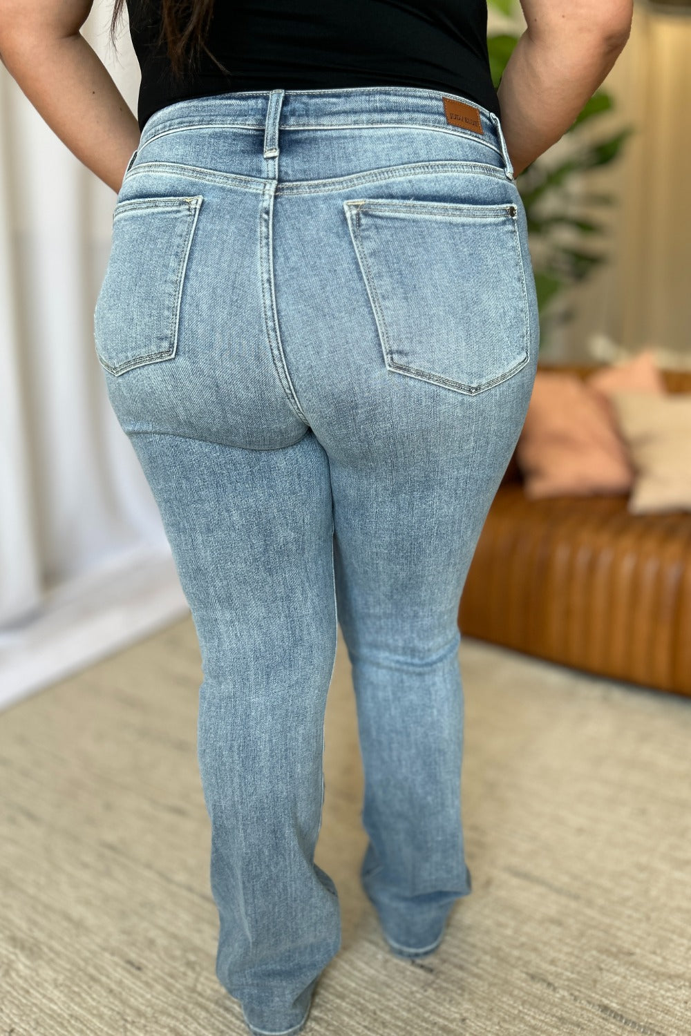 Medium Rise Bootcut Jeans by Judy Blue in light wash. Flattering medium rise, slight flare silhouette, moderate stretch for all-day comfort. Perfect for pairing with boots or heels.