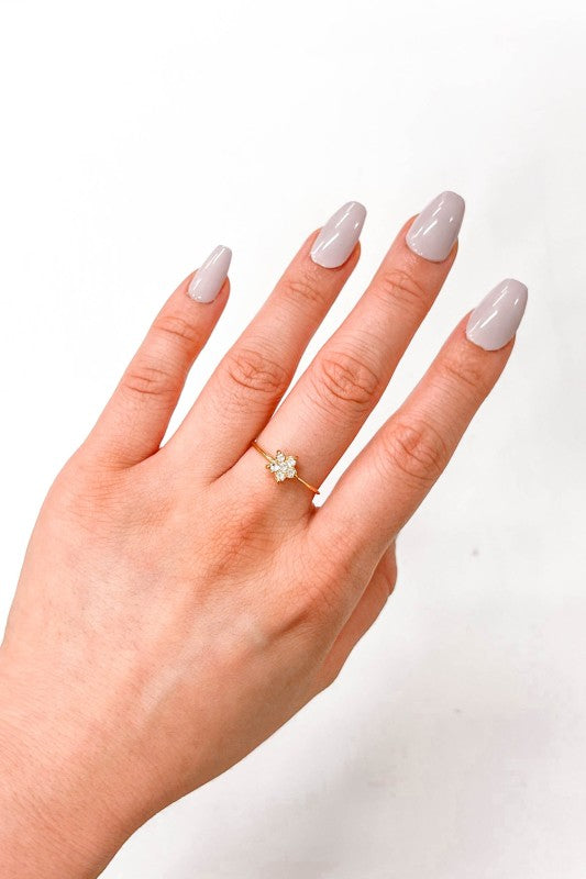 Stella Adjustable Star Ring styled on woman’s hand, gold band with star charm and crystals