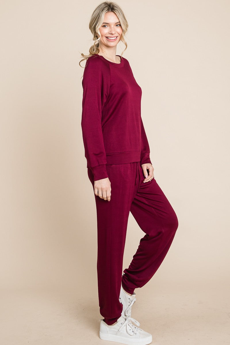 Burgandy lounge set with a round-neck top, raglan sleeves, and drawstring pants.