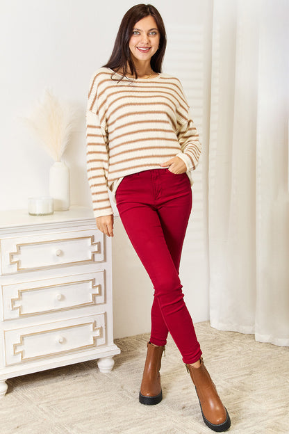 Model styled in Ryanne Striped Boat Neck Sweater with casual bottoms, chic striped knit look