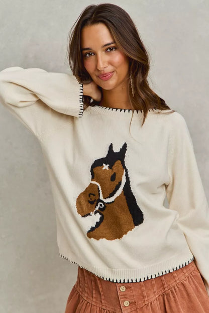 Woman wearing Dolly Horse Knit Sweater Top in ivory with horse print.