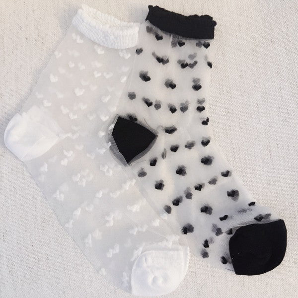 Flat lay of black and white Sweet Hearts Sheer Socks with delicate heart design.