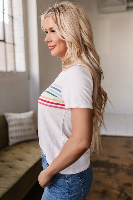 Side profile of Carter Rainbow Stripe Crewneck Top highlighting rainbow stripe placement and relaxed fit.