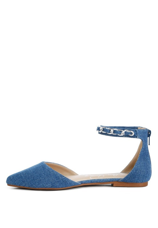 Denim flats with a pointed toe, chain ankle strap, and flat heel .