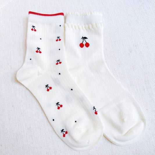 Flat lay of Cherries All Over Sock Set showing both red-trim and white variants.