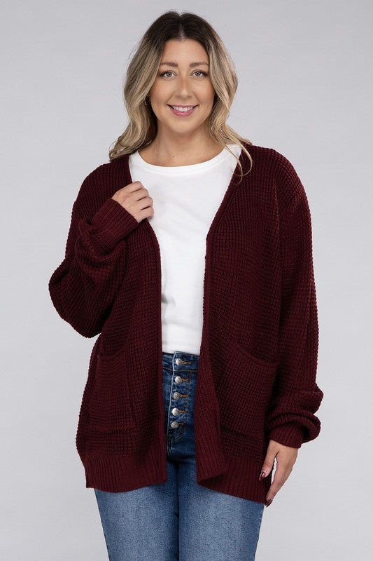 Curvy plus-size waffle-pattern open cardigan sweater in dark burgandy, with long sleeves, oversized fit, and pockets.