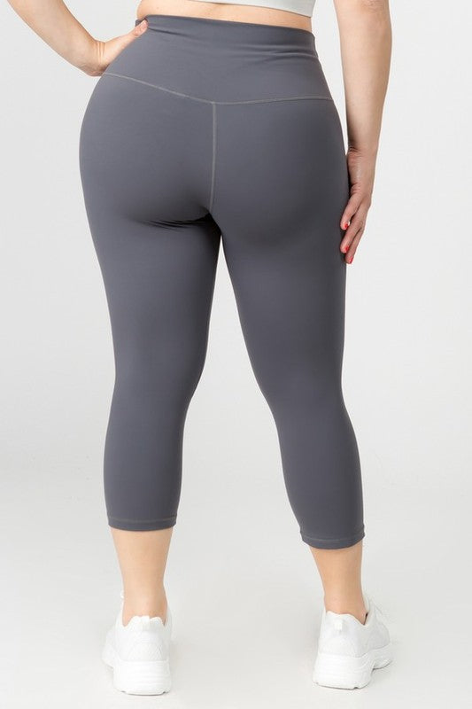 Charcoal high-rise capri leggings with a soft feel, wide waistband, and hidden pocket for essentials. Made with stretchy fabric.