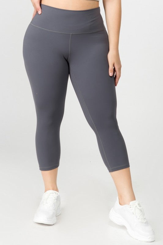 Charcoal high-rise capri leggings with a soft feel, wide waistband, and hidden pocket for essentials. Made with stretchy fabric.