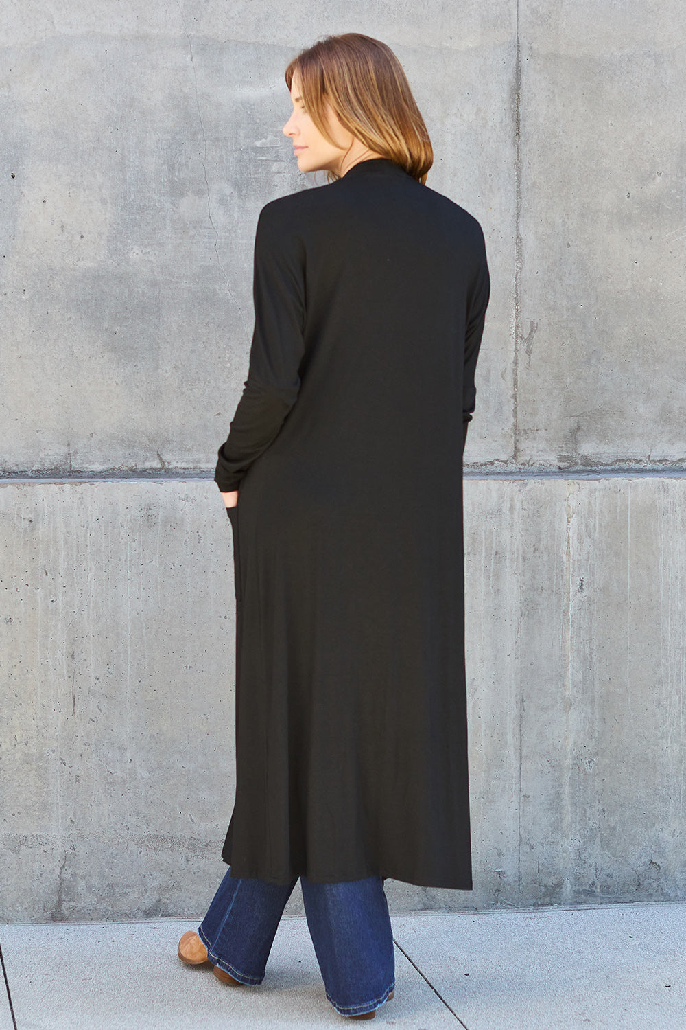 Black open-front long-sleeve cover-up with a flowy design and pockets, perfect for layering on breezy days.