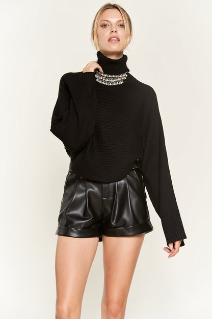 Giada Plus Size Mock Neck Wide Sleeves Sweater in black styled with shorts.
