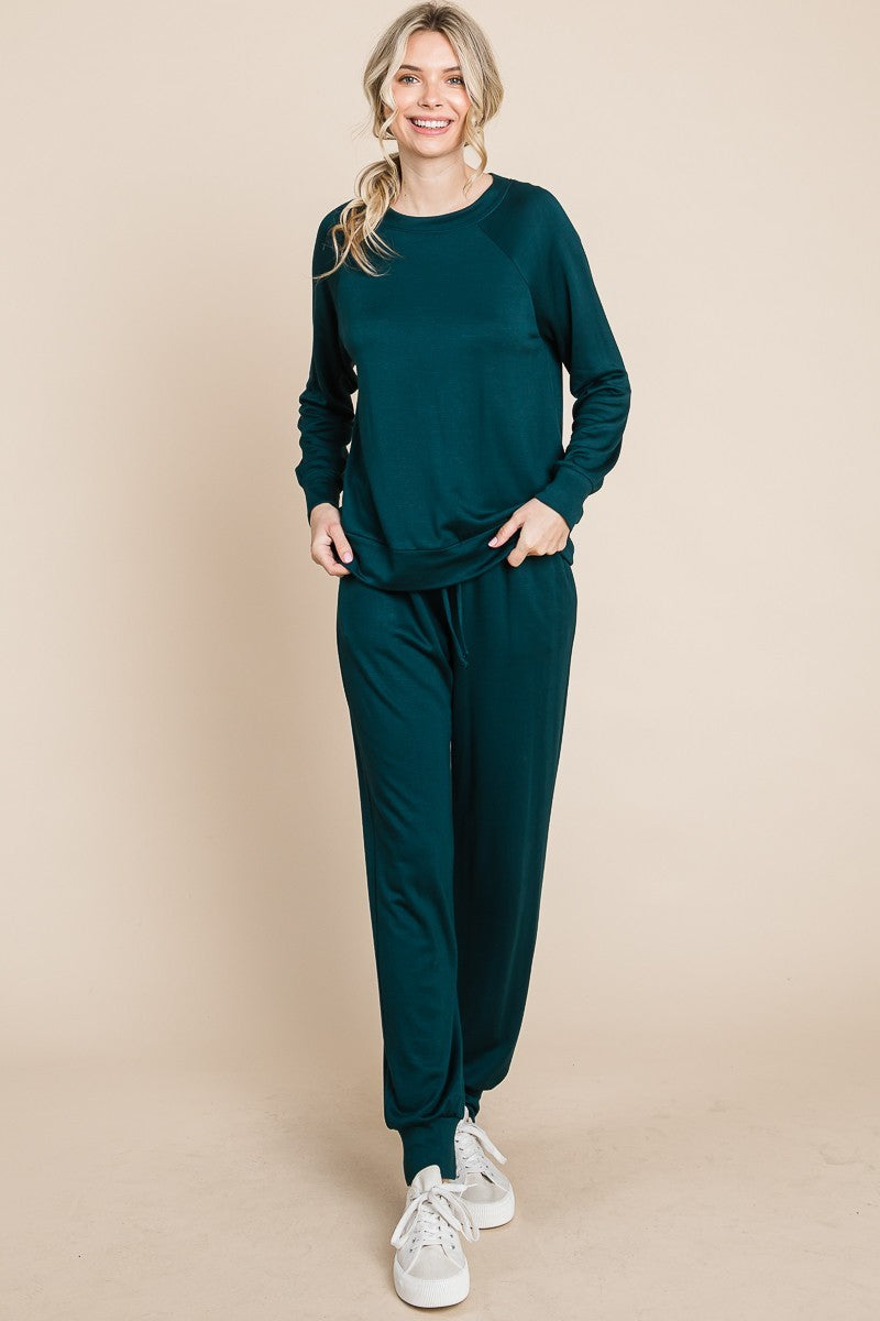 Hunter green lounge set with a round-neck top, raglan sleeves, and drawstring pants.