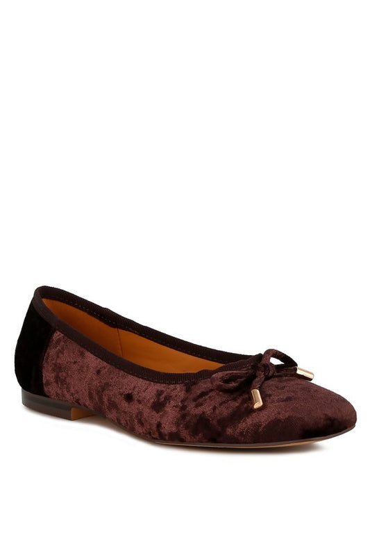 Brown velvet ballerina flats with a closed square toe, bow detail on the vamp, and cushioned insoles for comfort.