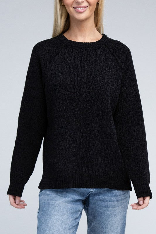 Black round neck chenille sweater with long raglan sleeves, relaxed fit, and hip-length cut.