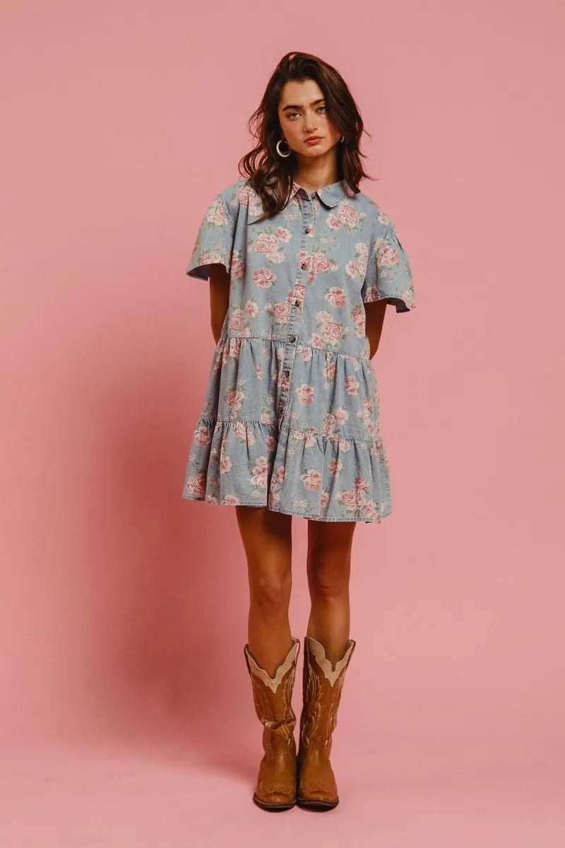 Another full body front view of model in Isla Floral Tiered Shirt Dress by BiBi, styled with boots and showing off light denim floral design.
